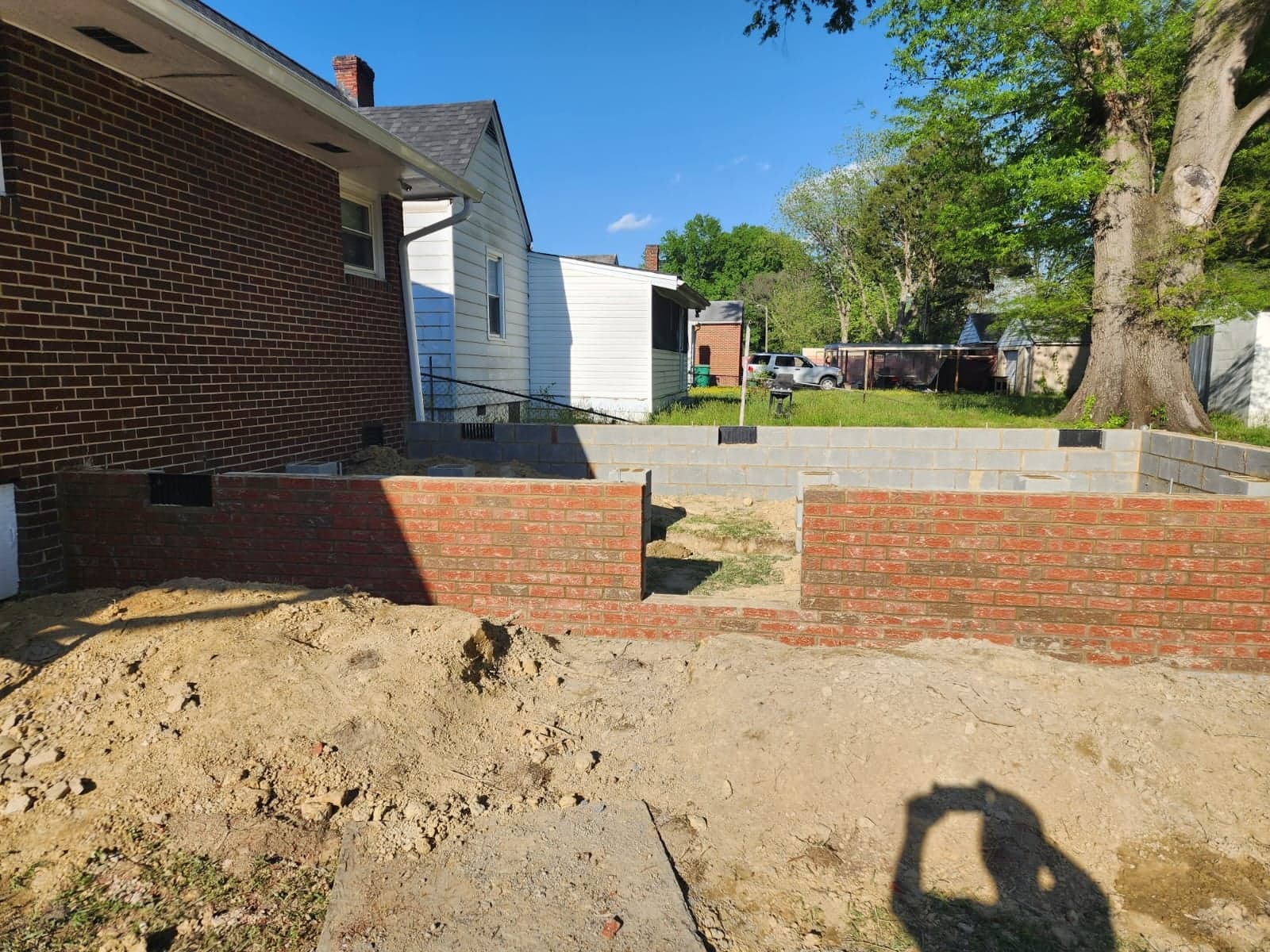 Block and brick foundation wall under construction for a home addition in Richmond, VA by MAS Contractors