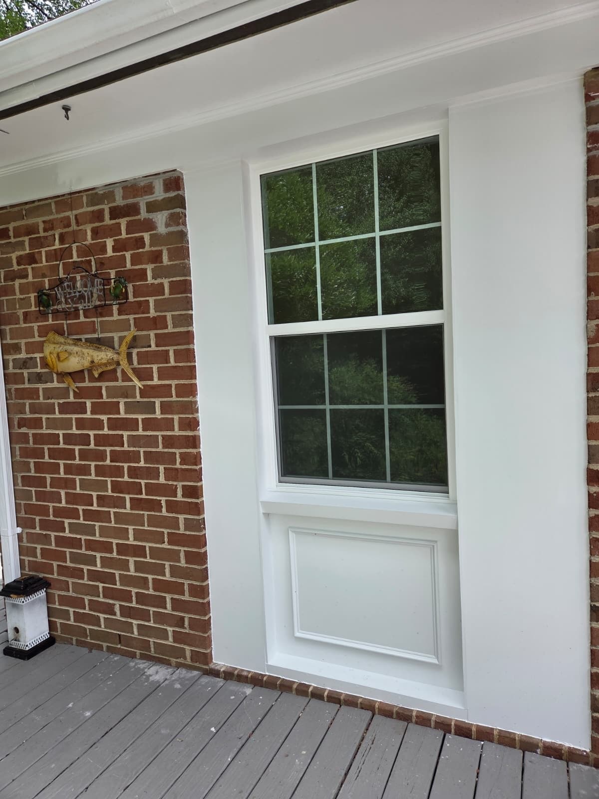 Close-up of new double-hung window with white casing trim installed by MAS Contractors in Richmond, VA