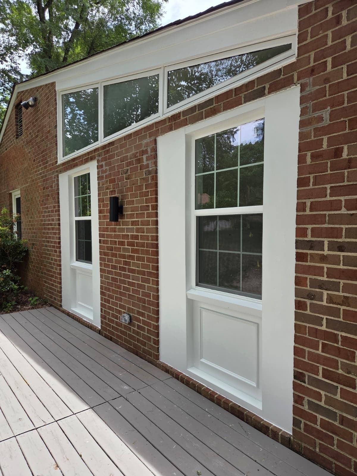 New double-hung vinyl window replacement on brick home exterior in North Chesterfield, VA by MAS Contractors